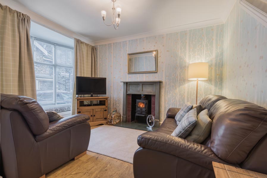 Comfortable lounge with leather sofas and wood-burning stove